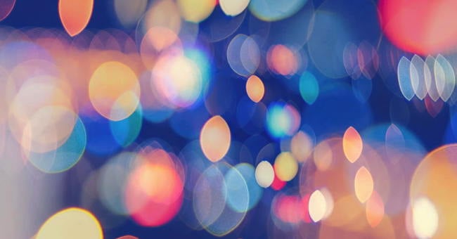 Sparkling colourful lights against a dark background.