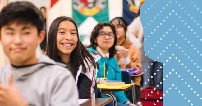 Students smilling in a high school classroom