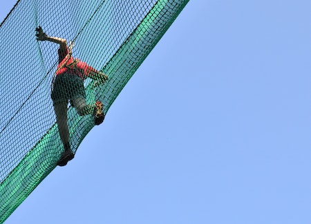 Making maths real for life. A student plays in a net in a rope course